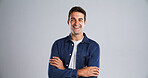 Portrait, happy man and arms crossed for fashion in studio with casual clothes or trendy style. Mockup space, laugh and male person with cool outfit, denim jacket and funny joke on gray background