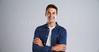 Buy stock photo Portrait, happy man and arms crossed for fashion in studio with casual clothes or trendy style. Mockup space, laugh and male person with cool outfit, denim jacket and funny joke on gray background
