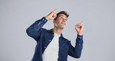 Buy stock photo Advertising, man and pointing to presentation in studio for announcement, coming soon or about us. Mockup, ambassador and marketing space for information, promotion offer and news on white background