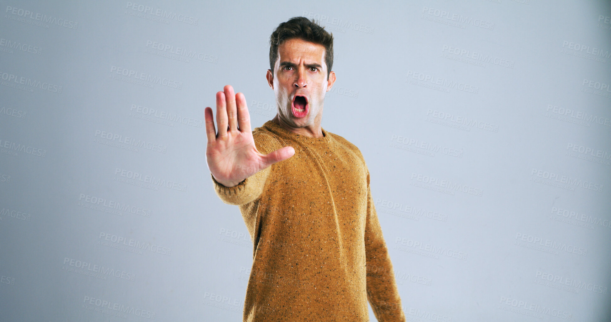 Buy stock photo Warning, stop and portrait of man in studio for rejection, deny or no hand gesture for protest. Shout, serious and male person with palm for caution, safety or self defense by gray background.