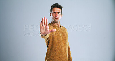 Buy stock photo Man, portrait and stop with hand out in studio for rejection, no or halt on a white background. Male person, model or disapproval with palm for warning, termination or cease fire on mockup space