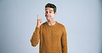 Portrait, space and man pointing up with mockup, product placement and isolated on white background. Promotion, information and person showing deal announcement in studio with choice, opinion or news