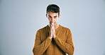 Man, prayer and hope for worship, anxiety and faith for God on white background. Spiritual stress, begging guidance and religion with portrait in studio for trust, opportunity and plea or question