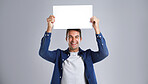Portrait, man and laugh with poster in studio for billboard, branding flyer and announcement. Smile, mockup space and show signage with person, news information and message notice on white background