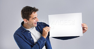 Buy stock photo Smile, man and blank paper in studio for billboard poster, branding flyer and announcement. Happy, mockup space and show signage with person, promo information and message notice on white background