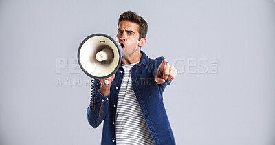 Buy stock photo Portrait, bullhorn and man in studio, screaming or angry with protest on white background. Facial expression, person or point with megaphone, frustrated or activism for human rights, noise or justice
