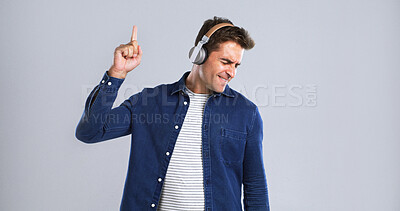 Buy stock photo Music, headphones and man with dancing for fun, online streaming or radio with mockup space in studio. Energy, listening with audio tech and sound for rhythm with male person on white background