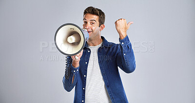 Buy stock photo Man, portrait and megaphone for announcement with pointing, advertising or promo in studio. Bullhorn, loudspeaker or news with male person for alert, mockup space or presentation on white background