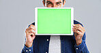 Man, hands and tablet with green screen for presentation or advertising on a white background. Male person, model or marketing with technology display, UI or UX for software app on mockup space