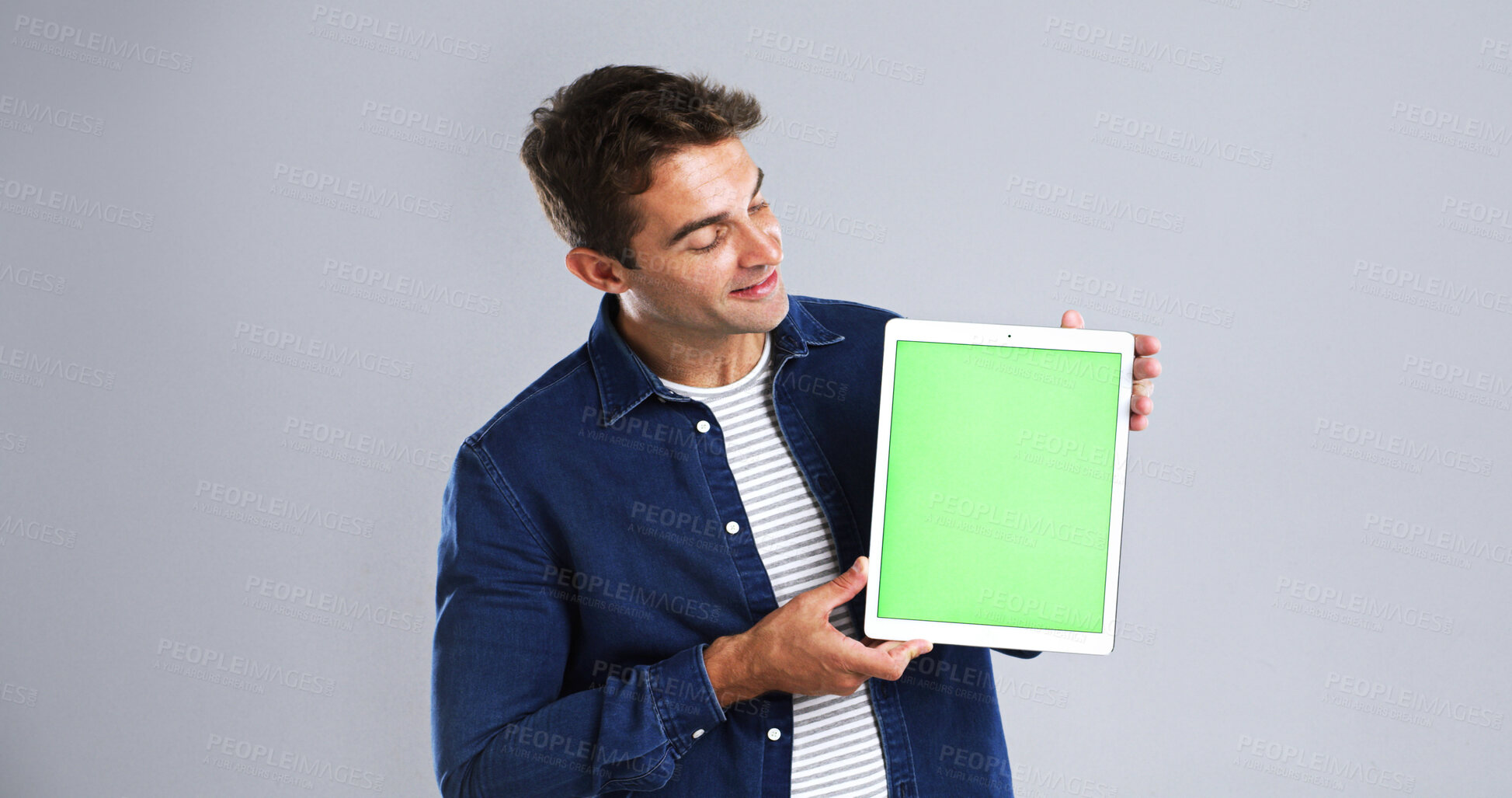 Buy stock photo Man, hands and tablet with green screen in studio for advertising on a white background. Male person, media or user with technology display, chromakey or app for marketing, UI or UX on mockup space