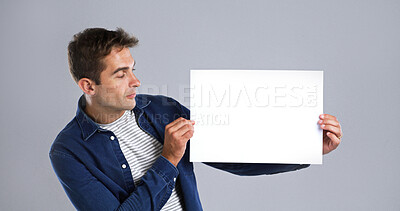 Buy stock photo Man, poster and mockup for advertising in studio, announcement or news for about us. Information, marketing and show space for presentation, person with billboard or promotion on white background
