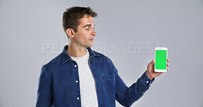 Buy stock photo Man, phone screen or chromakey in studio for advertising or presentation on a white background. Male person, model or user with green mobile smartphone display for UI, UX or marketing on mockup space