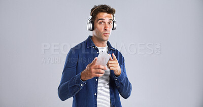 Buy stock photo Portrait, man and listen with headphones in studio for streaming music, radio and playlist. Mockup space, person and point with phone for song subscription, groovy audio and album on white background