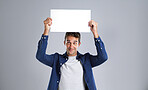 Smile, man and poster on head in studio for billboard, branding flyer and announcement. Happy, mockup space and show signage with person, promotion information and message notice on white background