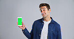 Man, portrait and phone with green screen for marketing new app, UI or UX on a white background. Male person, model or user with mobile smartphone display or chromakey for advertising on mockup space
