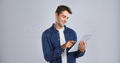 Buy stock photo Man, smile and scroll on tablet in studio for connection, internet or network on white background. Digital technology, mockup space and happy male person with touchscreen for social media or website 