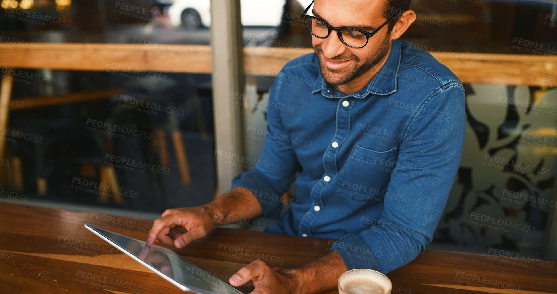 Buy stock photo Tablet, reading and man in coffee shop for remote work, scroll review or journalist check email. Technology, cafe and happy freelancer on internet to research news, report and editing story headline