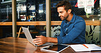Cafe, man and reading on laptop for freelancer, article information and online blog for publication. Coffee shop, male person and content writer with digital for remote work, newsletter and editing