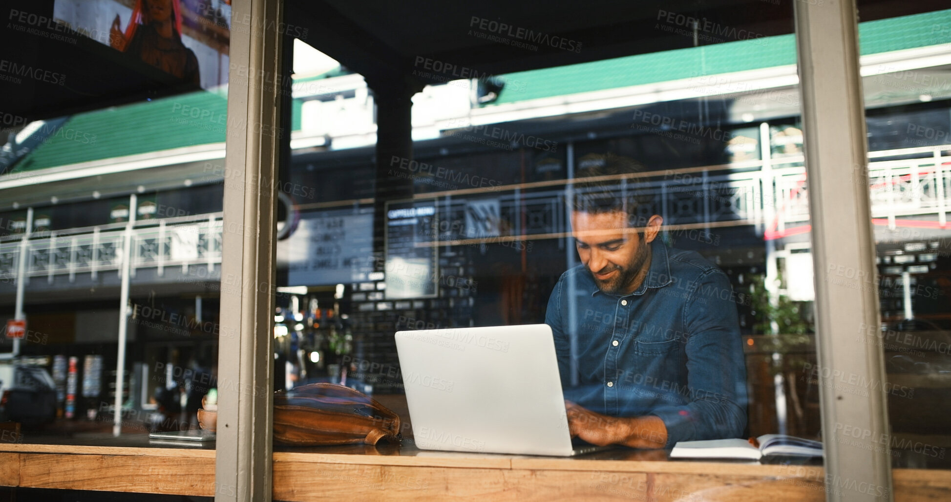Buy stock photo Coffee shop, laptop and businessman by window in cafe for typing report, proposal and research. Restaurant, freelance and person on computer for internet, online project and review for remote work