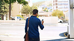 Phone, walking and back of man in city with mobile app for maps with commuting to work in morning. Technology, bag and male journalist with cellphone for directions with travel in urban town.