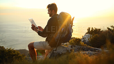 Buy stock photo Man, hiking and ocean view at sunset with tablet, break or relax for search on digital map in summer. Person, perspective and touchscreen by sea, mountain or app for direction with trekking in Greece