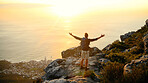 Ocean, mountains and man with open arms, back and water with fitness, challenge or nature. Sunset, hiker and person with exercise, hobby and seaside with break, celebration or achievement with cardio