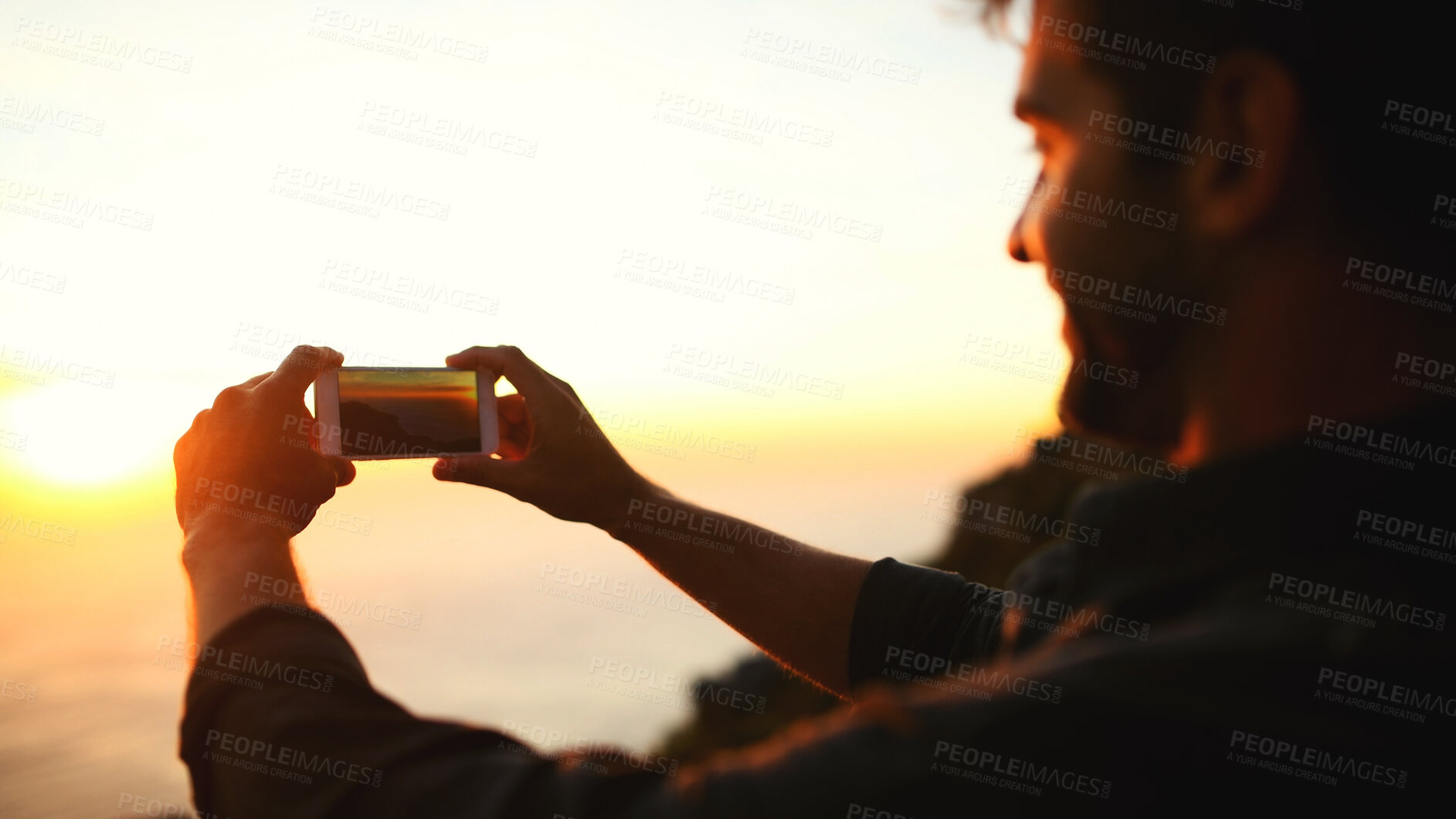 Buy stock photo Man, hands and phone with sunset for picture, photography or capture moment on outdoor adventure. Male person, hiker or travel with mobile smartphone camera for scenic view or memory on mountain
