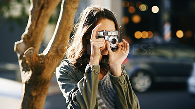 Buy stock photo Camera, photography and woman in city for travel on holiday, getaway or weekend trip with sightseeing. Equipment, tourist and female person capturing view for social media in urban town for vacation.