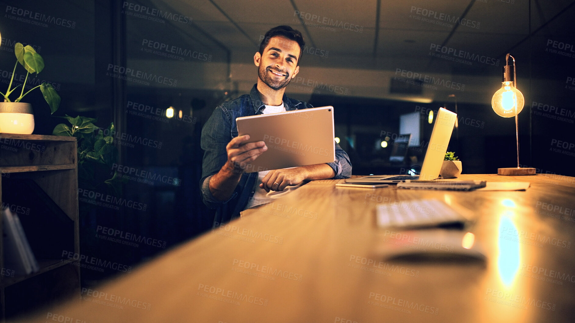 Buy stock photo Night, business and man with tablet, portrait and smile with graphic designer, app and web proposal. Person, overtime and employee in workplace, tech and internet for creative project and deadline