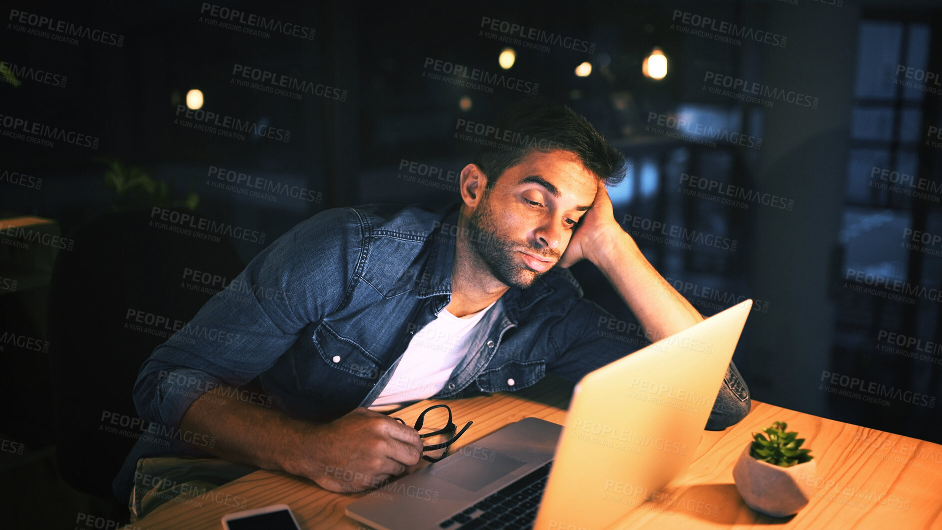 Buy stock photo Laptop, bored and business man in night office for research, copywriting deadline or project. Tired worker, frustrated and editor with fatigue, burnout or exhausted for editing news article online