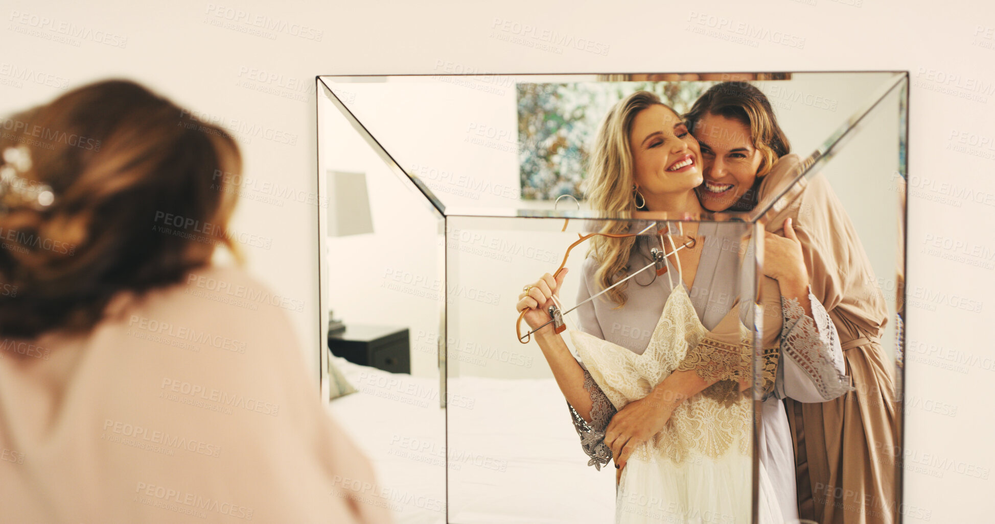 Buy stock photo Wedding, dress and hug with women in mirror for celebration, support and excited. Love, marriage ceremony event and getting ready with friends in bedroom of home for reflection, bride and happiness