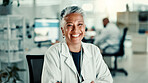 Mature woman, arms crossed and smile at lab with pride for medical research, study and portrait. Person, scientist and happy with confidence, career and pharmaceutical project for vaccine development