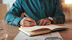 Person, hands or writing with book at night for reminder, schedule or business notes at office desk. Closeup, employee or journalist working late with pen in notebook for diary ideas, agenda or tasks