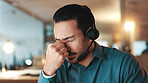 Night, customer service and man in office, headache and burnout with deadline, pressure and tension. Evening, person and agent in workplace, migraine and stress with pain, call center and fatigue