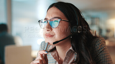 Buy stock photo Headset, reading and thinking with woman in call center for assistance, help or support at night. Communication, computer and problem solving with person at office for customer service in evening