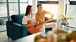 Challenge, fun and gaming with couple on sofa in living room of home together for bonding or dating. Competition, remote control and video game with happy people in apartment for entertainment