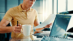 Laptop, documents and man with coffee in office with finance proposal for investment planning. Cappuccino, computer and male financial advisor with paperwork for company budget report in workplace.