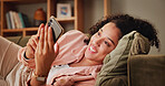 Home, smile and woman on sofa, smartphone and relax with message to contact, app and social media. Apartment, mobile user and happy person on couch, cellphone and communication with chatting and text