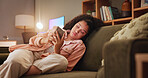 Woman, bored and phone with texting on sofa, tired and doom scroll with subscription on social media. Girl, smartphone and click on mobile app at night, chat and annoyed on couch in lounge at house