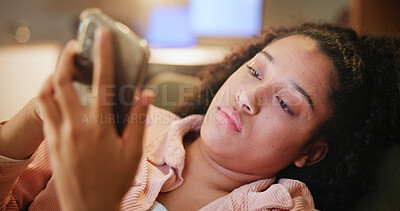 Buy stock photo Woman, bored and phone with texting on couch, tired and contact with scroll on social network. Girl, smartphone and click on mobile app at night, chat and annoyed on sofa in living room at apartment