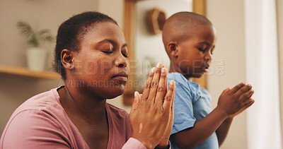 Buy stock photo Praying, religion and black mother with child in home for worship, praise or spiritual wellness. Bonding, hope and African mom teaching boy kid with christian prayer in morning for gratitude in house