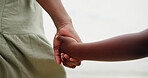 Holding hands, parent and child at beach on vacation with care, love and bonding in nature. People, kid and support with connection, outdoor and holiday for family with back, ocean and getaway by sea