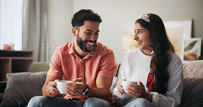 Buy stock photo Couple, happy and coffee on sofa with conversation, care and bonding with love in living room at house. People, man and woman with smile, drinks or tea cup on couch for laugh with funny chat in home