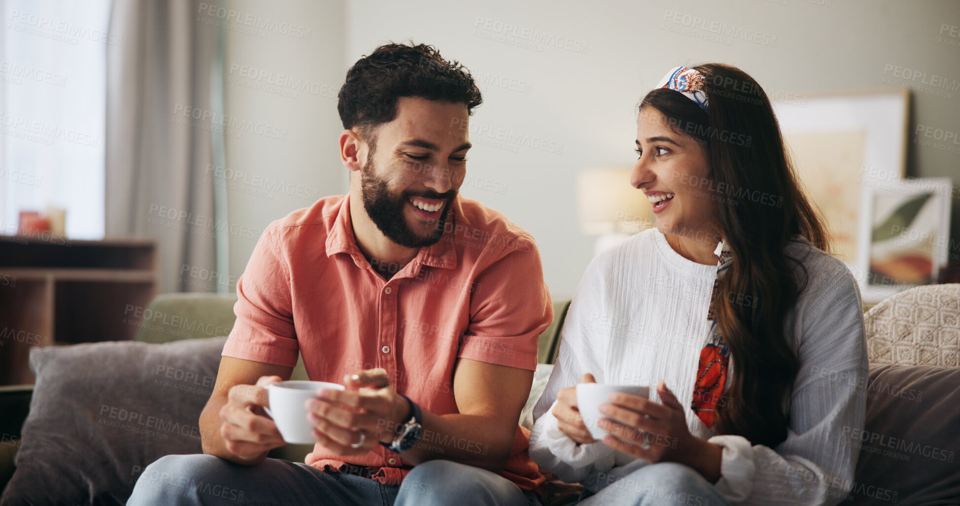 Buy stock photo Couple, happy and coffee on sofa with conversation, care and bonding with love in living room at house. People, man and woman with smile, drinks or tea cup on couch for laugh with funny chat in home