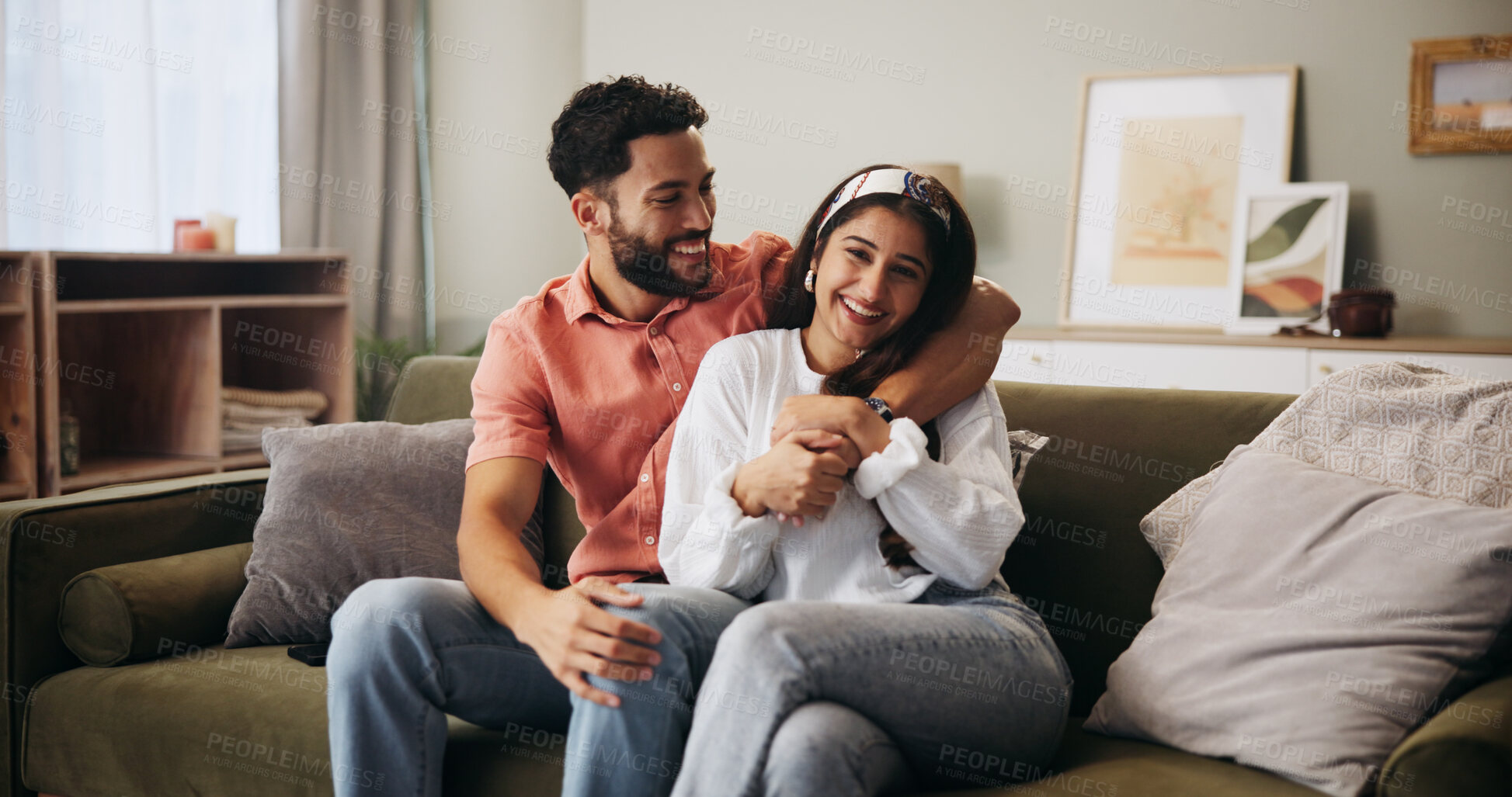 Buy stock photo Hug, happy couple and laugh in living room with smile, bonding and weekend date in apartment. Embrace, man and woman with portrait in house for relationship, marriage or joke in home lounge for break