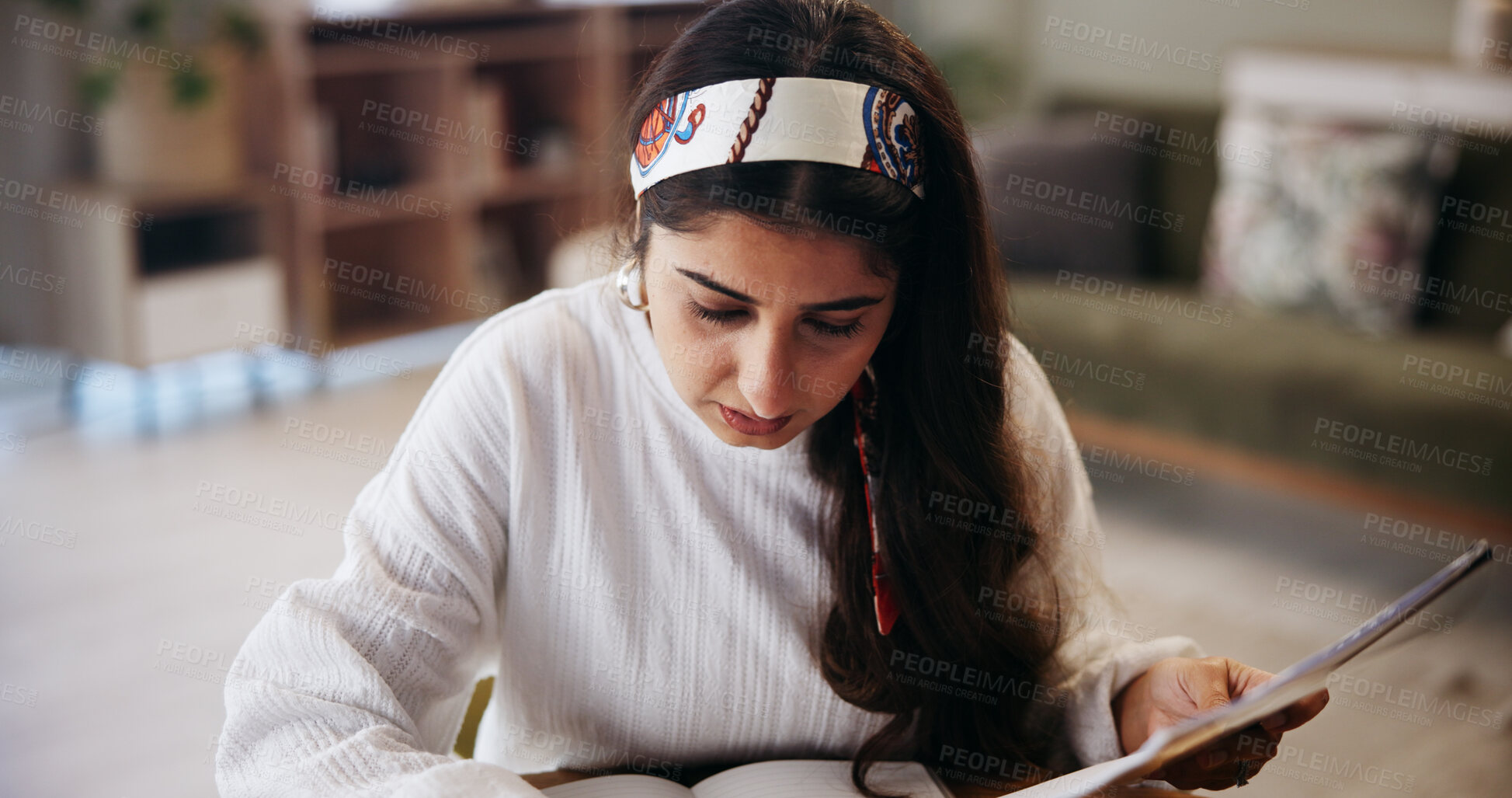 Buy stock photo Student, woman and studying in home with book for test preparation, thesis or knowledge. Learning, education and serious person in living room for college assignment, project and reading information
