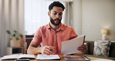 Buy stock photo Finance, bills and man in home with documents for financial planning, savings and investment. Reading, payment and person with paperwork, budget and invoice for mortgage, tax review and report