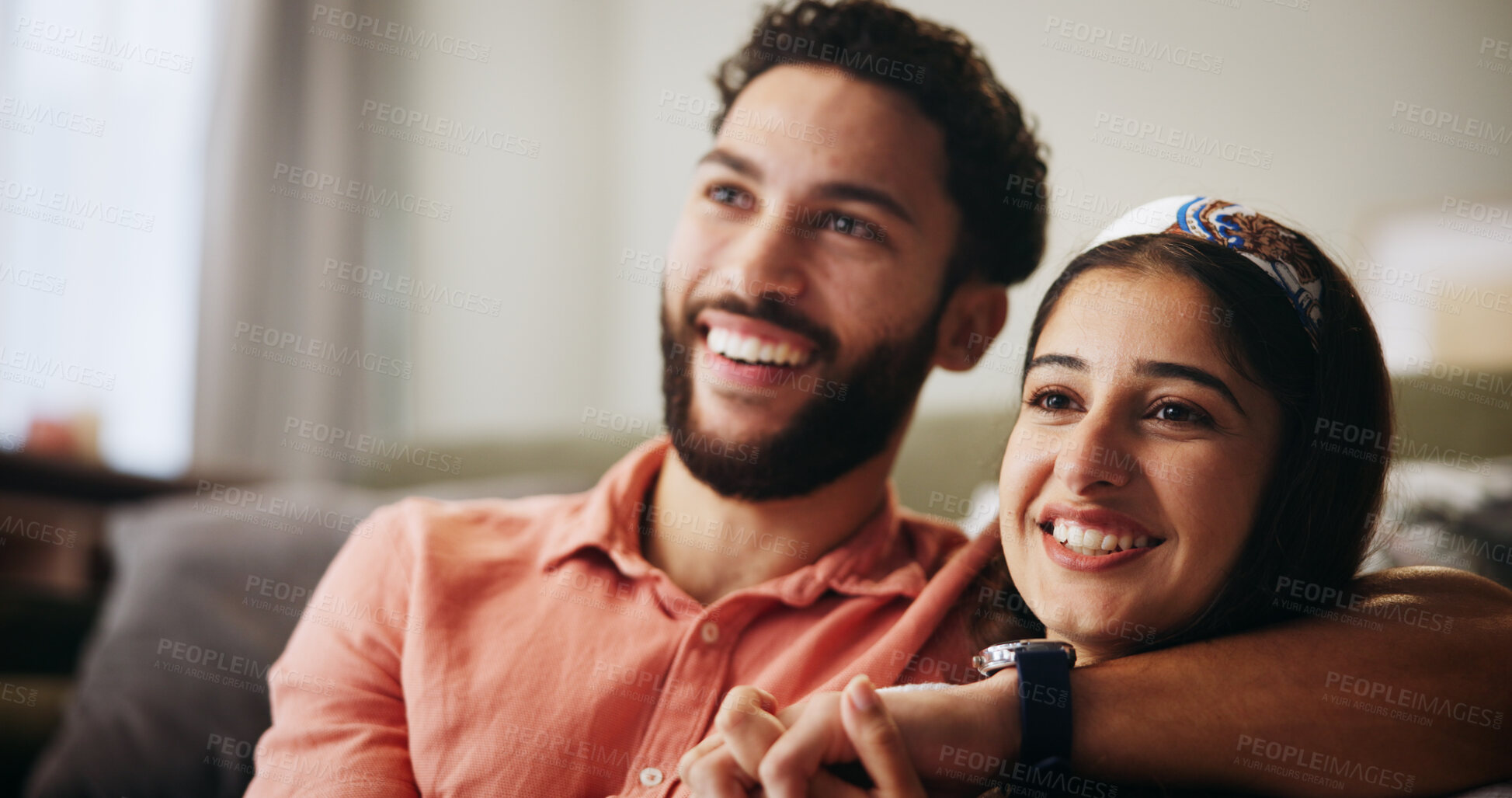 Buy stock photo Couple, happy and watching tv on sofa with hug, relax and bonding with movie in living room at house. People, man and woman with holding hands, care and streaming with film subscription at apartment