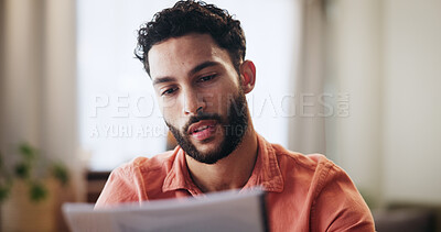 Buy stock photo Reading, finance and man with paperwork in home for mortgage, loan payment and taxes. Worry, apartment and person with documents, bills and report for budget, financial planning and review savings
