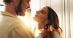 Couple, happy and eye contact in home with care, love and bonding by window with connection in morning. Man, woman and smile with trust, loyalty and memory with partnership for romance at apartment